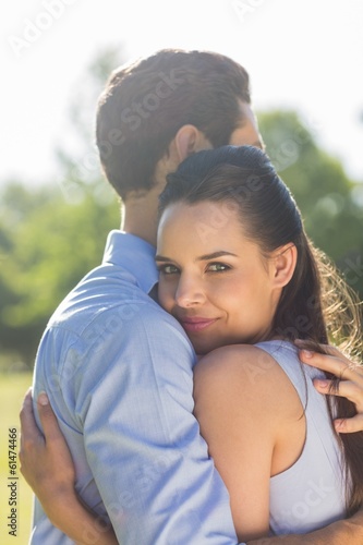 Side view of young couple embracing at park