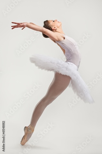 Young ballerina dancer in tutu performing on pointes