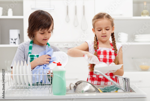 Kids washing the dishes in the kitchen