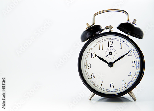 black old style alarm clock isolated on white