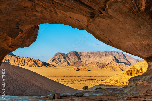 View through a rock arch in the desert of Wadi Rum