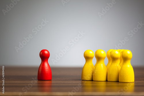 Red pawn figure against united yellow, isolation, confrontation,