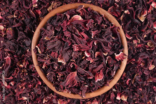 Dried petals of hibiscus in a wooden bowl