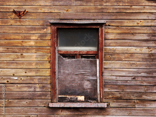 wooden wall with a board up window