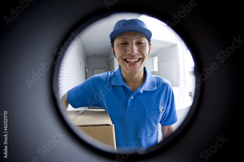 delivery person seen through peep window