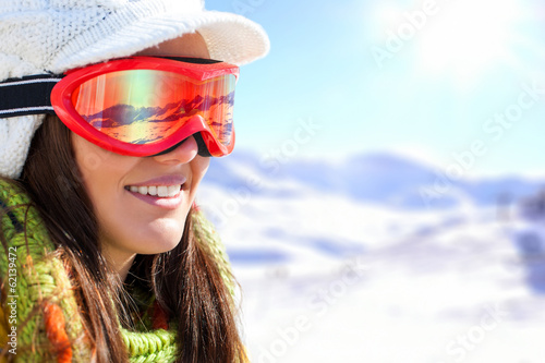 Young female skier with goggles.