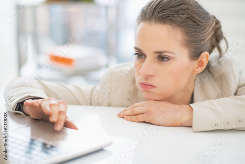 Frustrated business woman working with laptop in office