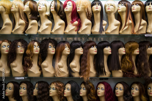 rows of mannequins ina wig shop