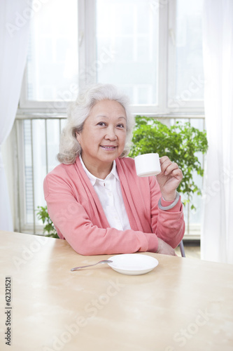 Senior woman holding a tea cup.