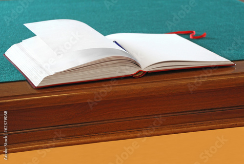 Open guestbook on the table with green cloth