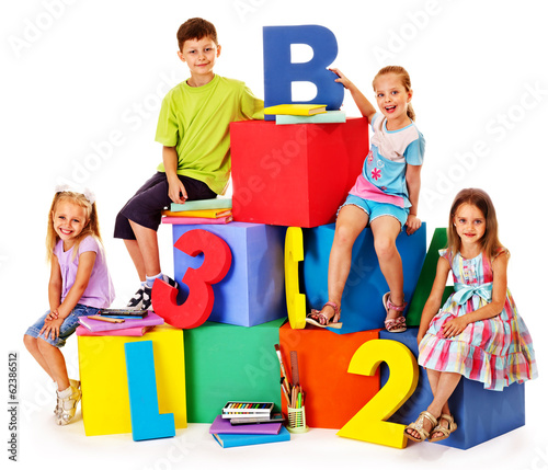 Children sitting at cube.