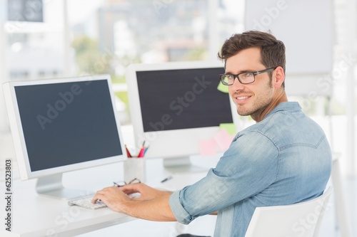 Side view portrait of a male artist using computer