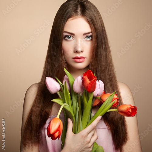 Portrait of beautiful dark-haired woman with flowers
