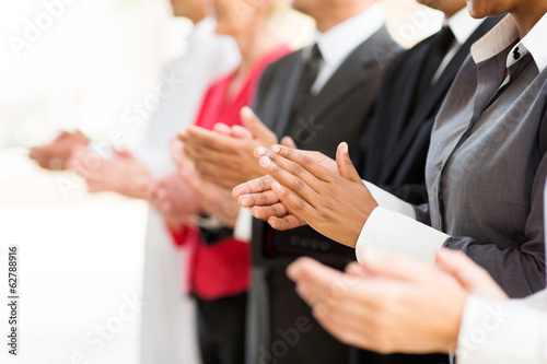 group of businesspeople clapping hands
