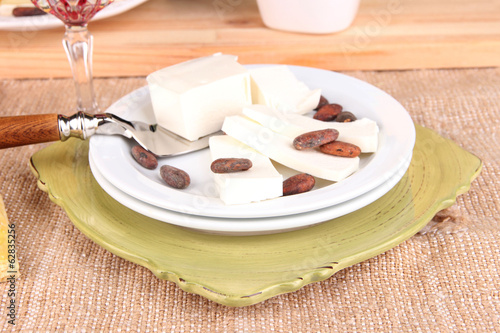 Assorted cheese plate on table background