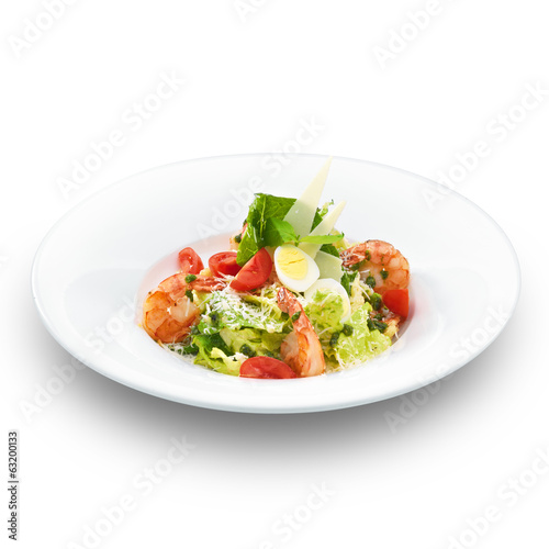 Fresh delicious italian caesar salad with royal shrimps. Isolate