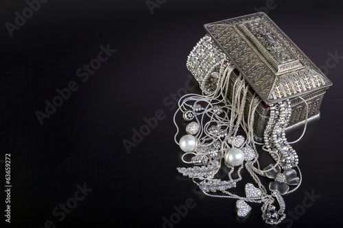 Silver jewelry on black background