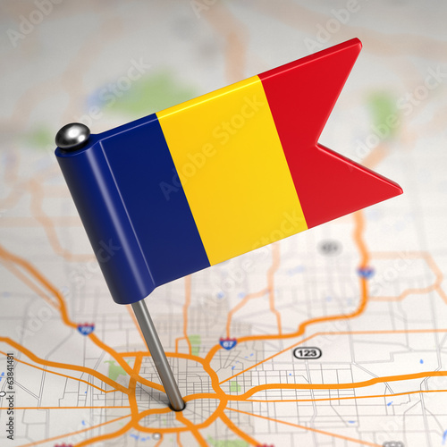 Romania Small Flag on a Map Background.