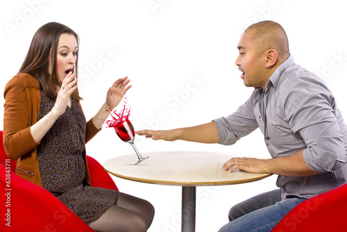 clumsy man spilling a drink on his date