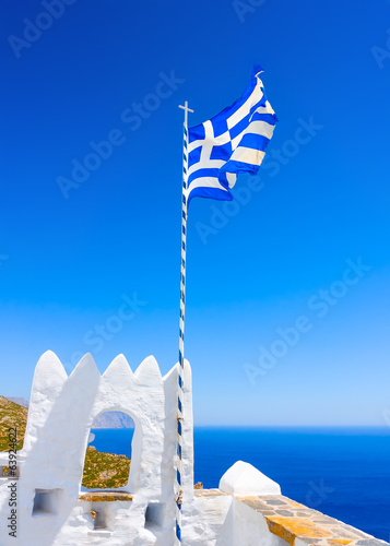 Greek flag fluttering in a Monastery in Amorgos island in Greece