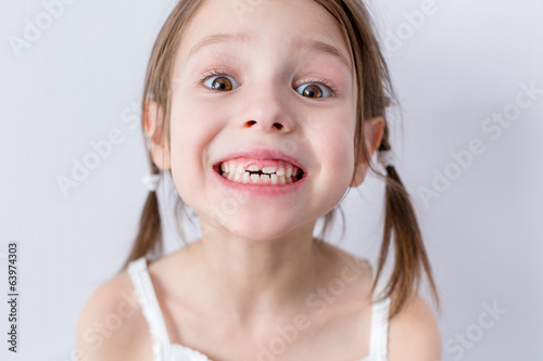 Close up portrait of preschooler girl with wide smile