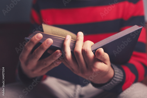 Man is reading a big book