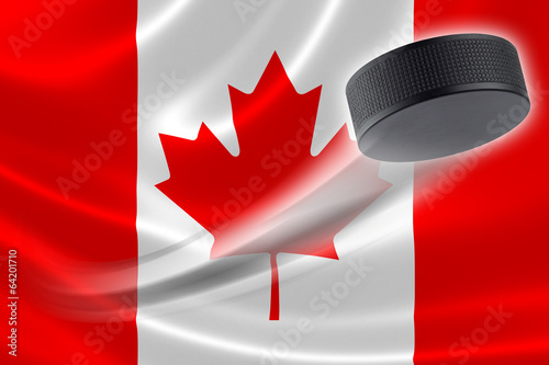 Hockey Puck Streaks Across Canadian Flag