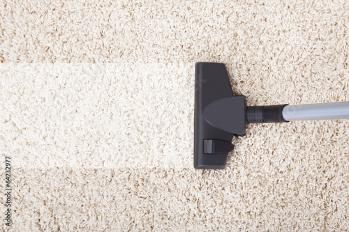 Vacuum Cleaner On Rug At Home