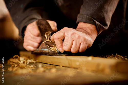 Senior man doing woodworking