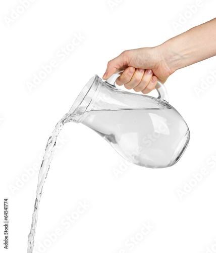 Pouring water from glass pitcher, isolated on white