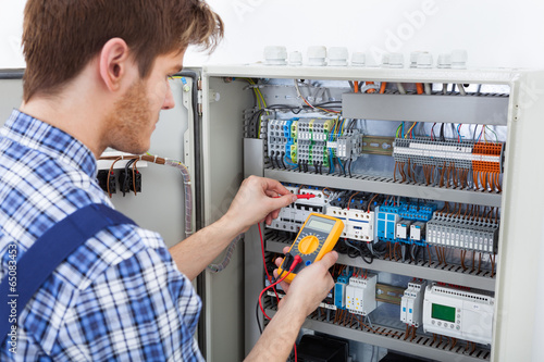 Technician Examining Fusebox With Insulation Resistance Tester