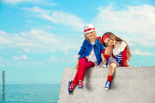 Fashion kids resting on the sea