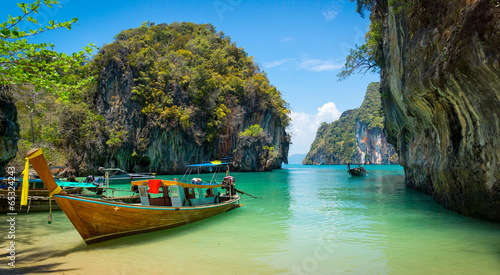 Traditional longtail boats near tropical island