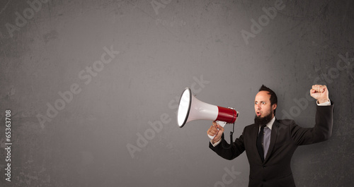 Guy shouting into megaphone on copy space background