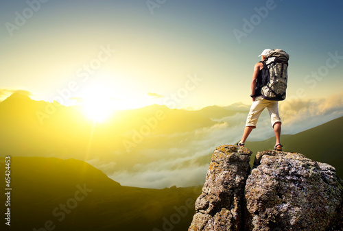 Tourist on rock. Sport and active life concept