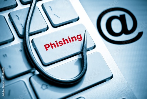 phishing / fish hook on computer keyboard with email sign