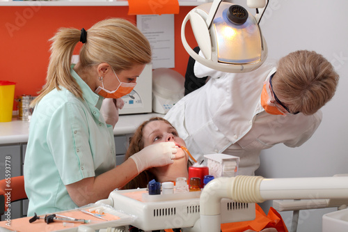 Dental procedure, student patient and professor tooth examine