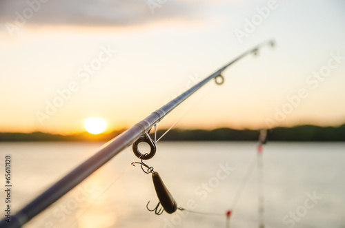 fishing on a lake before sunset
