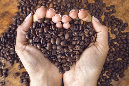 Heart shaped coffee beans,handheld.