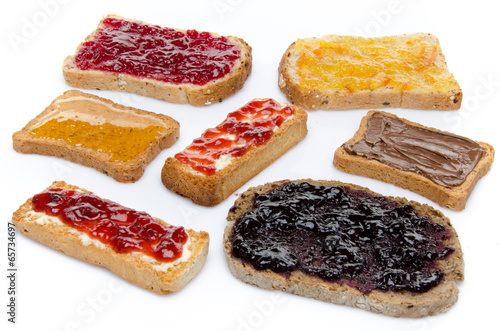 Some toasts with jams, honey and hazelnut spread