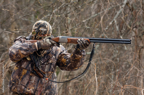 hunter takes aim from a gun