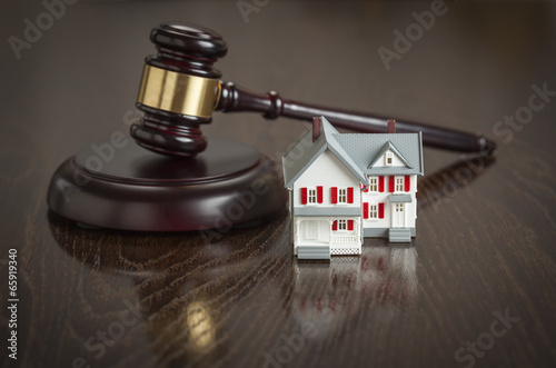 Gavel and Small Model House on Table