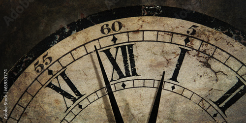 Grunge old Clock showing the Time is After Midnight