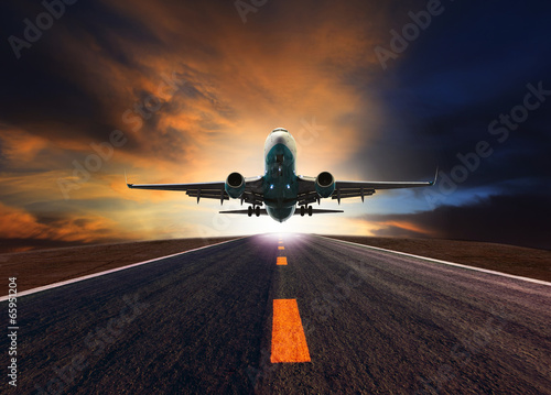 passenger jet plane flying over airport runway against beautiful
