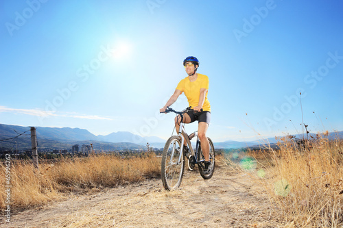 Male biker riding outdoors on a sunny day