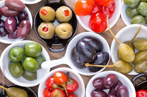 Colorful assortment of cured olives and peppers