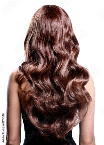 Back view of brunette woman with long black curly hair.