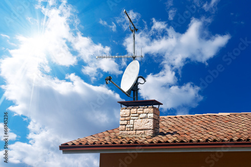 Satellite Dish and Antenna TV on Blue Sky