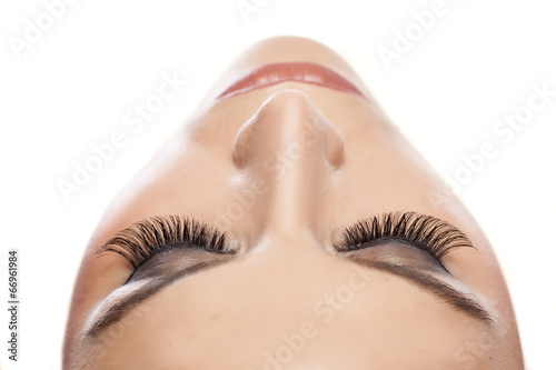 female eye with long false eyelashes