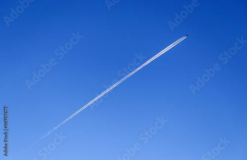 contrail in a blue and orange sky